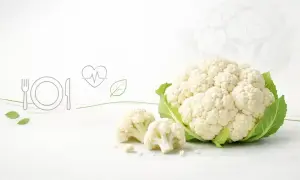 Cauliflower, symbolizujący zdrowie i lekkostrawność, na białym tle. Ikony talerza, serca i liścia podkreślają jego dietetyczne walory.